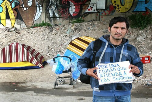 Figure 1. Dorin holding the banner “For a city that cares for the homeless”. Photo by the author (2018) with permission from the respondent. (page 16).