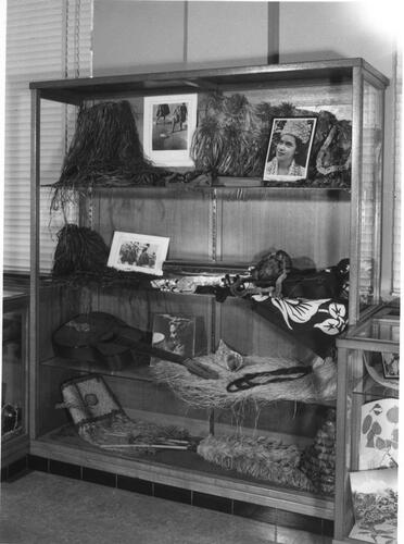 FIG 9 Display case with fibre skirts, musical instruments and photographs of dance performances in the Documentation room focusing on Hawai‘i at the Damien Museum around 1960 (Courtesy of Damien Collection, Leuven).