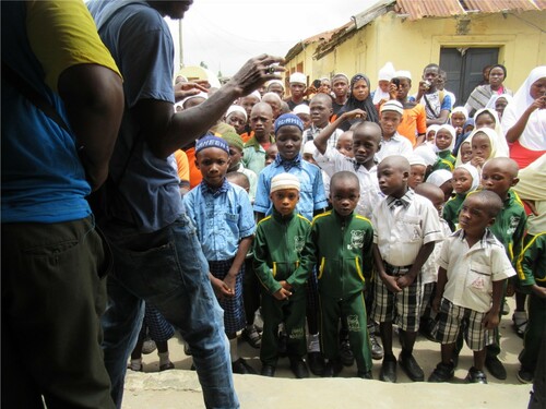 Figure 4. Children on School Visit to Barracoons Listening to Tour Guide. Copyright Faye Sayer