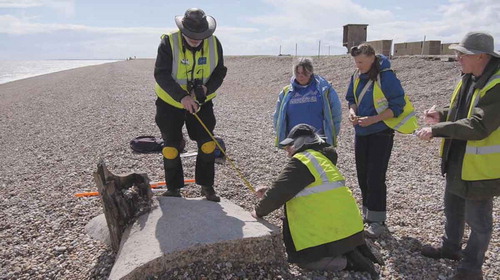 Figure 1. Screenshot from ‘Recording Loss’ of volunteers engaging in archaeological recording at Orford Ness, supervised by CITiZAN archaeologist Lara Band (second from left).
