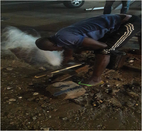 Figure 6. Private plumber repairing a burst pipeline in Nima (March 10, 2020).