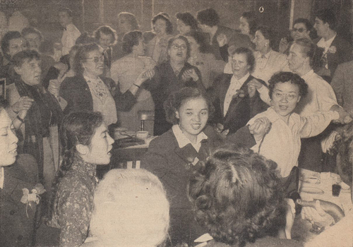 Figure 1. Women’s meeting at the WFTU’s Third World Trade Union Congress 1953. “During their impressive meeting, the women express their common will in song.” In the background, among others, Nina Popova (secretary of the Central Council of the Soviet Trade Unions) and Teresa Noce (secretary general of the Trade Unions International of Textile and Clothing Workers)Footnote12.