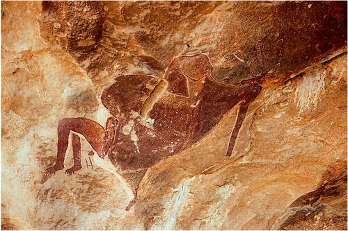 Figure 5. In Lesotho’s Sehlabathebe National Park is a 1m long painting of a ritual specialist heralding the potential dangers of a superabundance of resources that concentrate seasonally at altitude (Challis Citation2019). With bulging stomach (evoking associations of gluttony and poor resource distribution), tusks, and three legs with clawed toes (evoking leonine proportions of both power and gluttony), the figure in question may represent just such an instance of the strong ritual specialist struggling to control excess fat and potency while dealing with the entities above and below the water. Image courtesy of James Pugin.