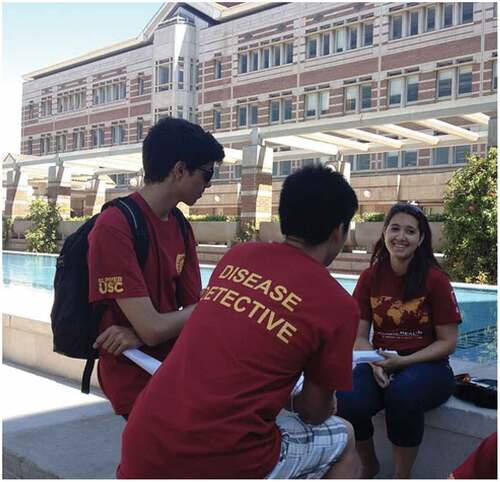 Image 1. Summer high school students carry out a mock disease outbreak investigation on the USC campus wearing their course t-shirt.