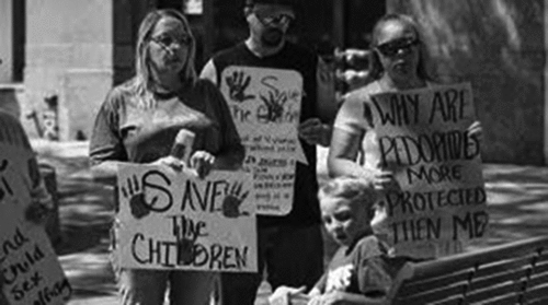 Figure 5. QAnon demonstrators with signs reproducing the claims of ritualized sexual abuse that were common during the Satanic Panic of 1980-1990. (Source: WYSO/BBC World Service, 19.05.2021).