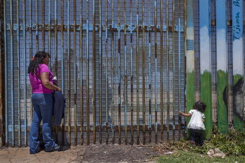 Figure 5. Griselda San Martin, Olga Camacho and her granddaughter Yara, who is 2 years old, visit Olga’s son Jonathan, who she hasn’t been able to hug in 13 years. Jonathan benefited from DACA (Deferred Action for Childhood Arrivals) and has been able to stay and work in the United States legally. However, the Deferred Action benefit does not allow individuals to leave the country and return freely. Photograph © Griselda San Martin.