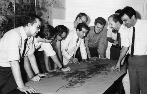 Figure 3. The planning team working on the TMP in the Tehran office, 1968. Fereydoon Ghaffari, in the middle of the photo who has a pen in hand, presents the plan to the team.Source: Fereydoon Ghaffari.