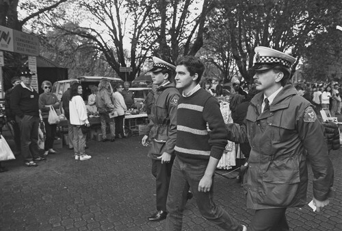 Figure 4. Rodney Croome being arrested at Salamanca Markets, Tasmania, Australia, 1988. Photo: Roger Lovell.Footnote182