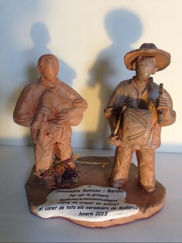 Figure 3. Clay figurine by Ricardo Gago of a xeremier (left) and flabioler (right) given as a present at the end of the author's fieldwork. Translation of inscription: ‘To Cassandre Balosso-Bardin. For being the first musician/ethnomusicologist capable of crossing alone the path of all the xeremiers of Mallorca, winter 2013.’