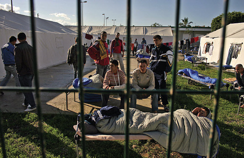 Figure 7: Melilla, 2007 Migrants sometimes travel for four to six years to reach the Spanish side of the border. Some attempt to cross via the sea, swimming for hours to avoid detection, some attempt to smuggle themselves in the engine compartments of trucks, and some simply try to climb over the barrier. Others still succeed in crossing only to be held in Spanish-government-run temporary migrant holding centers, some for years, awaiting the legal system to either award them papers or deport them.