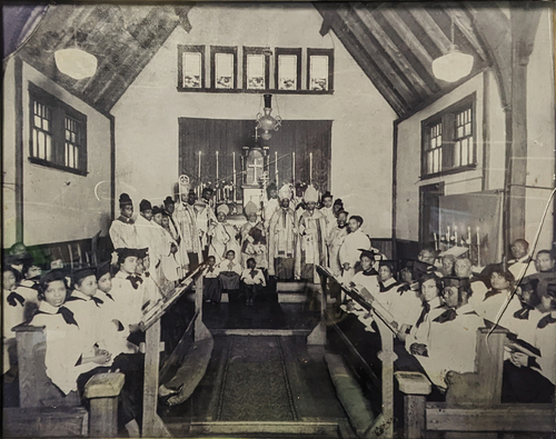 Figure 7. A circa 1930 photograph of the church sanctuary with clergy and choir. Photograph courtesy of St. Augustine’s African Orthodox Church.