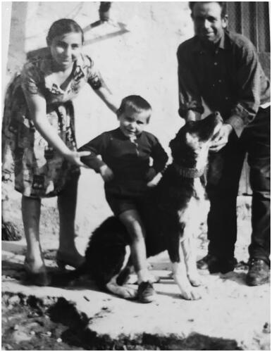 Figure 1. Photo of a Sicilian family with their 4-month-old Mannara dog wearing the typical spiked leather collar (Palermo, 1968).