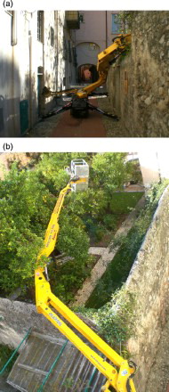 Figure 5. Final configuration of the MEWP after the collapse: (a) street view; (b) aerial view.Note: MEWP = mobile elevating working platform.