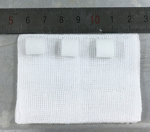 Figure 1 Gentamicin sponge cut into pieces of 1×1 × 0.5 cm.