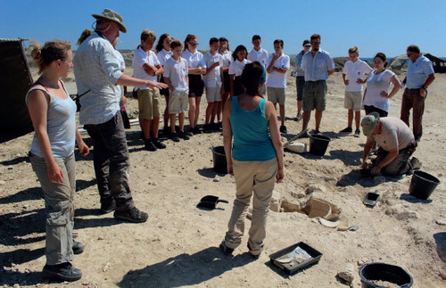 Outreach: staff and students explaining excavation of an amphora to a visiting school group.