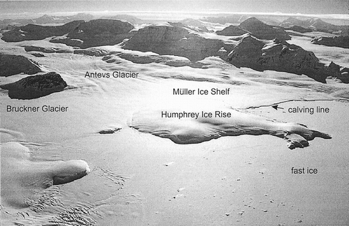 FIGURE 3. Oblique aerial view southwest over the Müller Ice Shelf to the mountains of the Arrowsmith Peninsula in November 1996 showing the Humphrey Ice Rise in the center-ground. The study site is at the right. Photograph by D. Vaughan, British Antarctic Survey.