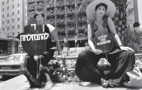 Every Thursday since 1988 Israeli women have demonstrated against the occupation of the West Bank and Gaza. They work in coalition with Palestinian women and others. These two women, among 30 women present, were in Haggar Square in West Jerusalem. The woman on the right with the large hat identified as an Israeli Palestinian Jew. “What an identity crisis I must have,” she humorously said. PHOTO BY ALAN POGUE