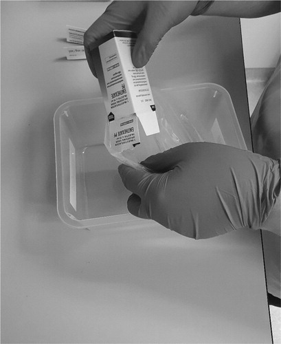 Figure 1. Transferring the vials with cytotoxic drugs into the plastic bag.