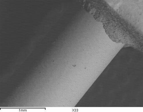 Figure 13 Representative SEM of sandblasting treated group attached to composite core (original magnification 33) demonstrating adhesive type of failure.