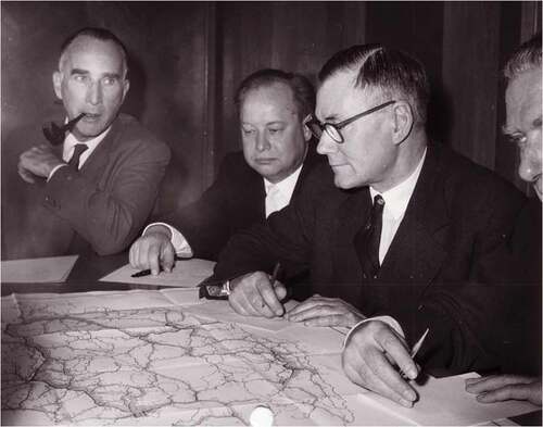 Figure 2. Infrastructural Europeanism in practice: studying a 1955 E-road traffic census map. (Left to right) W. Moser (Switzerland), A. Agafonov (USSR) and E.D. Brant (UK) of the Transport Division of the United Nations Economic Commission for Europe studying a map on the 1955 Road Traffic Census. Despite Cold War divisions, East and West continued to collaborate on infrastructure-related issues at the European headquarters of the United Nations. UN Photo.