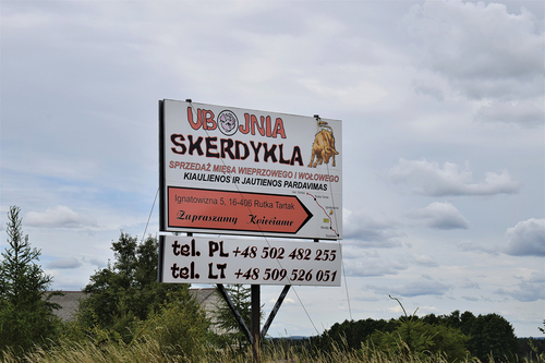 Figure 3. A bilingual (Polish above, Lithuanian below) billboard advertising a slaughterhouse and meat producer in Poland. © [Gintarė Kudžmaitė].