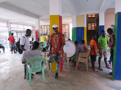 Figure 2. Drummer Ebenezer (aged 24) combines a dashiki shirt with a baseball cap, jeans and sneakers for the Accra West Brigade Band’s rehearsal.Photo by the author © Katharina Gartner 2016 in Darkuman, Accra, Ghana. Reuse not permitted.
