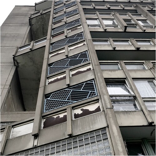 Figure 3. Robin Hood Gardens. Former view of external circulation with degradation of windows and concrete. Image courtesy of Greyscape, 2018. Robin Hood Gardens; Taking from the Poor to Give to the Rich [online]. Available from: https://www.greyscape.com/robin-hood-gardens/ [Accessed 12 November 2022].