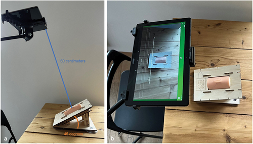 Figure 1. a and b Research setup with a Lenovo P10 tablet in a stand and a simulator by PediatrickBoxx.
