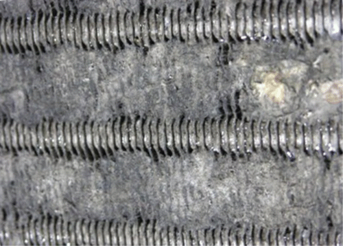 Fig. 2. Close-up of fouling at PSU site, upstream side of coil. Note the accumulation of fouling at the space between the tubes.