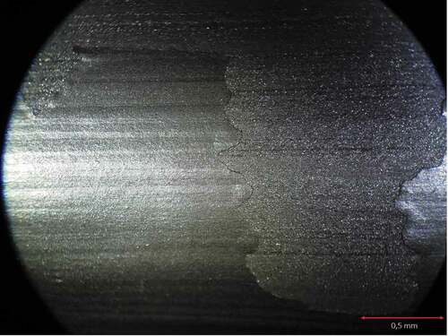 Figure 8. Tearing due to detachment of a tape from the surface, after a day of drying, reveals a laminated layer structure due to the leafing effect. The leafing effect may cause low abrasion resistance of the painted surface. AP made by the author according to an original recipe. Magnified photo by the author.