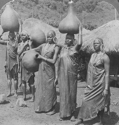 Figure 3.  ‘Kikuyu women with water vessels (gourds) beside village store houses. East Africa’ [#10551/U-116394].
