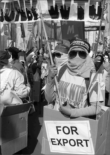 Fig. 8. Domestic workers wearing boxes marked “for export” and T-shirts reading “Junk WTO” were among the thousands of members of the Hong Kong People's Alliance (HKPA) who marched against the WTO on 18 December 2005.