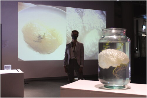 Figure 3. Image of Artist Anna Roberts standing with ‘Blooming Tumour (2021)’, ‘Crystal Universe (2021)’ and ‘Invasion (2021)’. [Photograph] Image Courtesy of Anna Roberts ©.