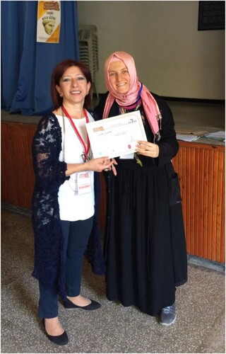 Figure 6. A volunteer being awarded a certificate of completion. (Photo credit: Aslı Öz for FETAV).