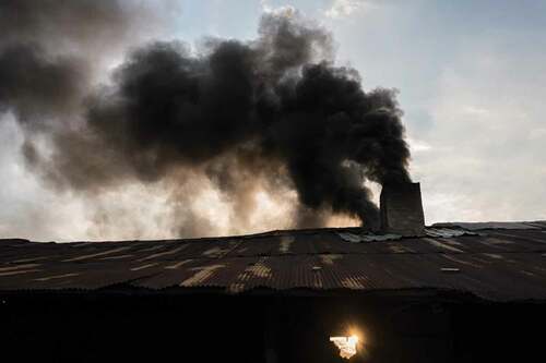 Figure 2. Black smoke emitted from a garment-fuelled brick kiln in Cambodia (Photo by Thomas Cristofoletti; copyright RHUL).