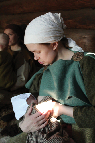 Figure 3. Reenactment offers opportunities to test Viking Age clothing in practical situations, such as nursing. Photo: Jenni Sahramaa.