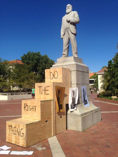 Figure 1. Flight, Nicolene Burger. Photograph by Open Forum Collective, Stellenbosch University, 2016. The staircase in this work can be viewed as a gesture to encourage Stellenbosch university’s patriarchal and racist past represented by the statue of Jan Marais, the institution’s first major benefactor to step down. The staircase also symbolizes a call for new leaders to step up in order for new and divergent histories to be archived and for new knowledge to be produced. Nicolene’s sculpture was installed on the university’s square, Die Rooiplein in October 2016 but was removed soon afterwards by the Campus Protection Services.