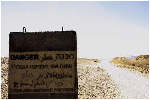 Figure 4. A sign marking the beginning of an area turned into a ‘Firing Zone’ almost completely surrounding a Bedouin village south-east of Hebron. This is Firing Zone 918. (UNOCHA, Citation2013, p.23–24)
