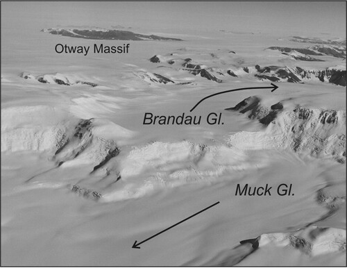 Figure 7. The upper reaches of Brandau Glacier are truncated due to headward erosion by Muck Glacier (locations on Figure 2). Brandau Glacier is about 6 km wide at its truncation. Arrows indicate direction of glacier flow. View towards the south-south west. Photograph enlarged from PGC/USGS photo TMA 781 R33 029.