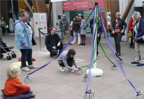 Figure 5. An audience member corrects a robot’s path during the PENELOPEan performance. Photo David Grifﬁths