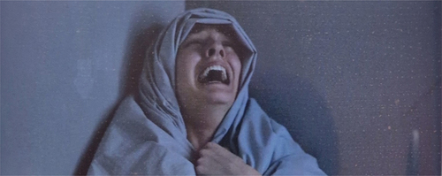 Figure 4. Bedcovers wrapped around her head, Sonia sobs after an argument with Catherine. Screenshot from Mention-Schaar’s Le Ciel attendra (UGC, Citation2016).