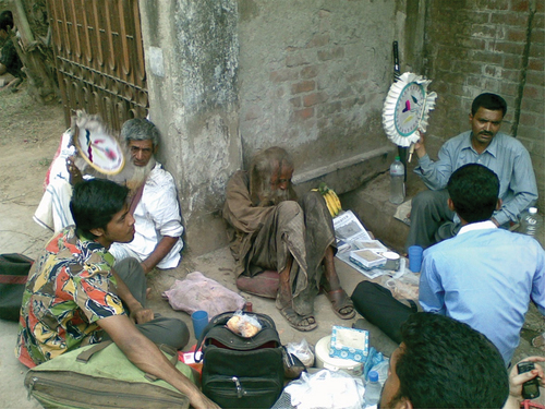 Image 5. Haidar Baba was lying on the ground leaning against the wall, and a group of his followers encircled him.Photo Credit: Ranadipam Basu; License: General Public License; Submitted with permission.