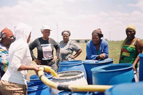 Figure 2. Somkhele women collecting water from a local source.(Source: Hargreaves Citation2016).