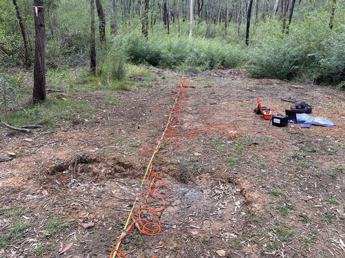 Figure 2. Fully set up ERT line, using a ZZ FlashRes64. The ERT line above is 16 m with a 0.25 m electrode spacing. The two orange 32 multi-core cables, which pass the electrical current, are attached to each of the electrodes and then attached to the ERT machine in the middle of the line. Power is obtained from a car battery with the ZZ software being run off a tablet.