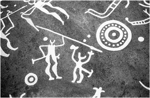 Figure 17. A motif found close to the battle scene at the Hede panel. Much like the scene placed above the battle motif, this scene could represent yet another instance of a possible weapon dancing ritual. While sedentary leg-wise, the figure on the left is waving its weapon and the figure on the right has its arms raised in possible adoration of the weapon-waving figure. These figures seem to be placed amongst various cupmarks and possibly discarded shields, suggesting a possible connection with power and battle. The repetition of this motif of ritualistic motion is interesting, especially when taking in its possible martial surroundings. (Swedish Rock Art Research Archives 2019)