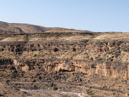 Figure 2. Apollo 11 Rock Shelter (in the middle, bottom third of the image) in the foothills of the Huns Mountains, Namibia. Photograph kindly provided by Ralf Vogelsang.