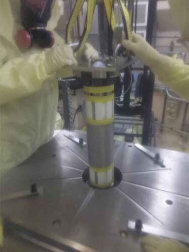 Fig. 5. Core and reflector components being lowered through the chamber mount assembly.