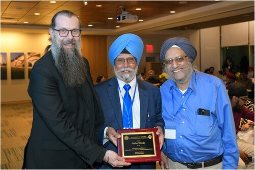 Figure 4. Michael Hawley was honored for his Alberta Sikh History Project by Amritjit Singh and Pashaura Singh.