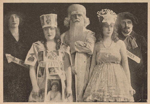 Figure 5 Claude Harris Studios, Alice ‘Lavender’ Lee and staff of Pictures and Picturegoer on their way to the Kinematograph Peace Pageant and Costume Ball, 9 May 1919, reproduced in “Long Shots”, Kinematograph & Lantern Weekly 32.629 (15 May 1919), 64–5, 64. © British Library Board (General Reference Collection LOU.LD94). From left to right: Elsie Cohen (assistant editor), Cissie Chrust (contributor and head of the magazine’s postcard department), Edmund Southwood ('Answers’ man), Alice ‘Lavender’ Lee and Fred Dangerfield (editor). See also Figure 6. Dangerfield and Cohen wear sashes with the names ‘Pictures’ and ‘Mrs Pictures’ respectively, and Chrust wears a sash with the name ‘Miss Pictures’, a persona that she used in her articles for the magazine.