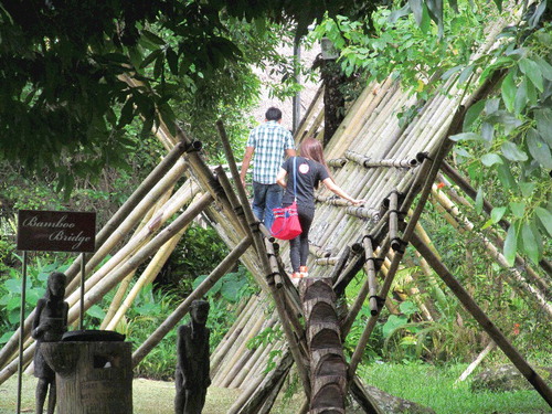 Figure 4. Tourists crossing ‘the bridge’ towards the Bidayuh house. Source: author.